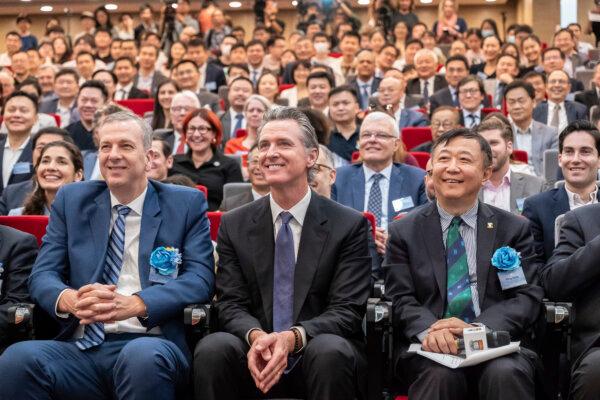 Visiting California Gov. Gavin Newsom (C) poses for a group photograph with guests following the fireside chat at the Hong Kong University in Hong Kong on Oct. 23, 2023. (Anthony Kwan/AP Photo)