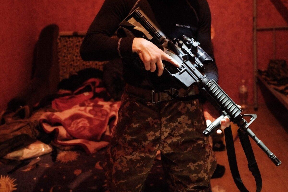 A Ukrainian serviceman checks his U.S-made M4A1 carbine after cleaning it at a base in the Donetsk region, Ukraine, on Feb. 23, 2023. (Yasuyoshi Chima/AFP/Getty Images)