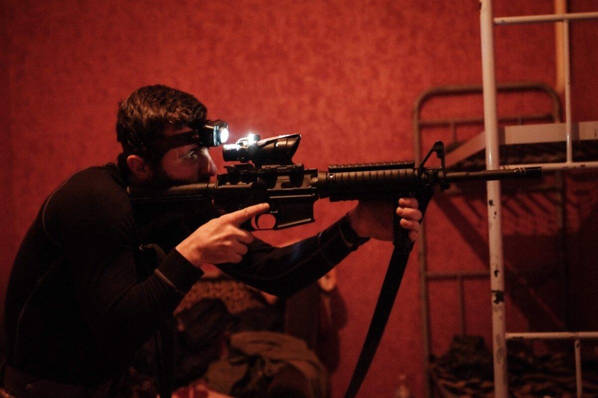 A Ukrainian serviceman checks his U.S-made M4A1 carbine after cleaning it at a base in the Donetsk region, Ukraine, on Feb. 23, 2023. (Yasuyoshi Chima/AFP/Getty Images)