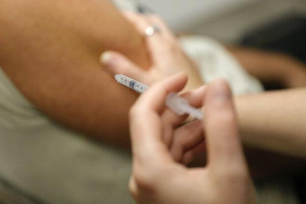 A man receives a dose of Comirnaty Omicron XBB 1.5 Pfizer vaccine for COVID-19 at a pharmacy in Ajaccio, on Oct. 5, 2023. (Pascal Pochard-Casabianca/AFP via Getty Images)