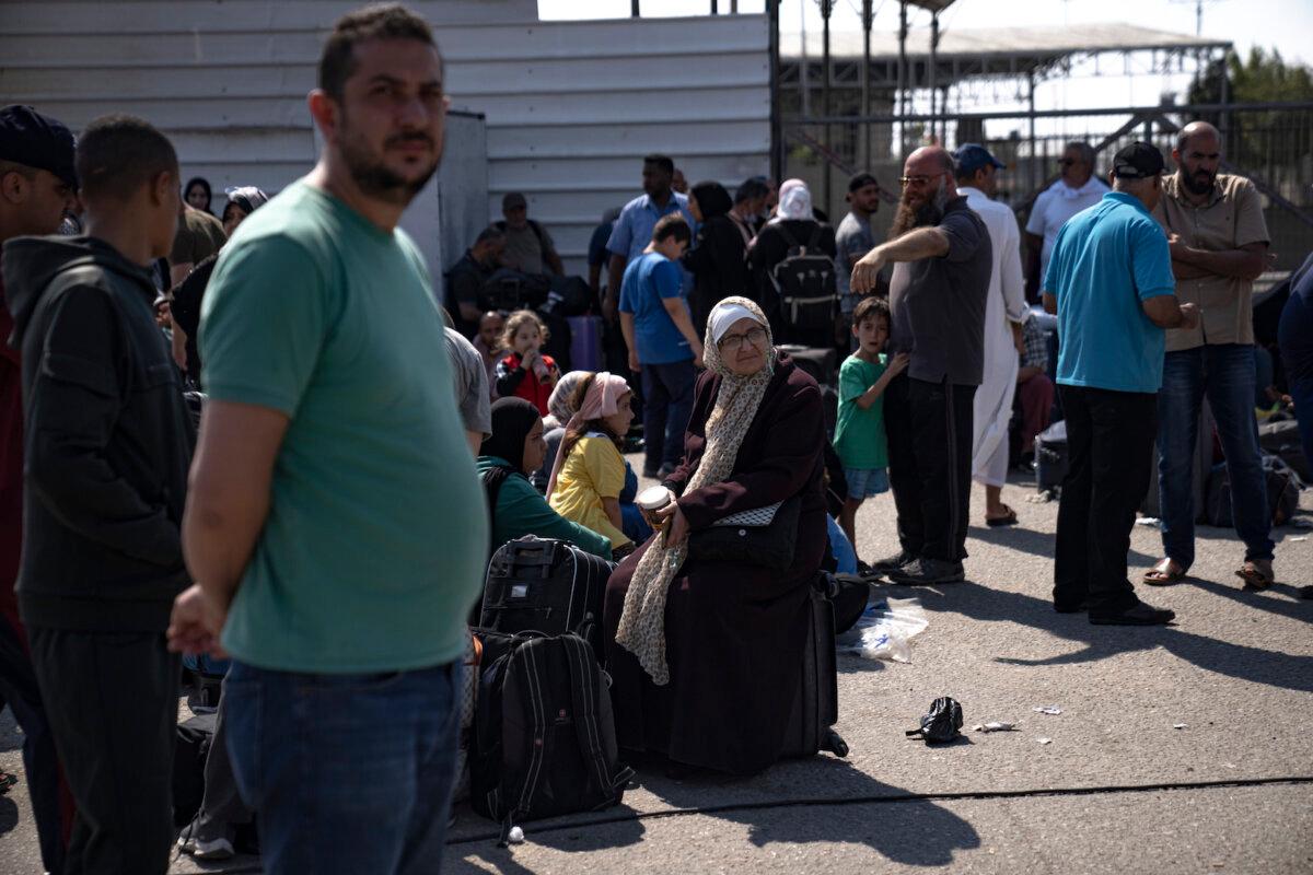 Palestinians wait to cross into Egypt at the Rafah border crossing in the Gaza Strip on Oct.16, 2023. (Fatima Shbair/AP Photo)