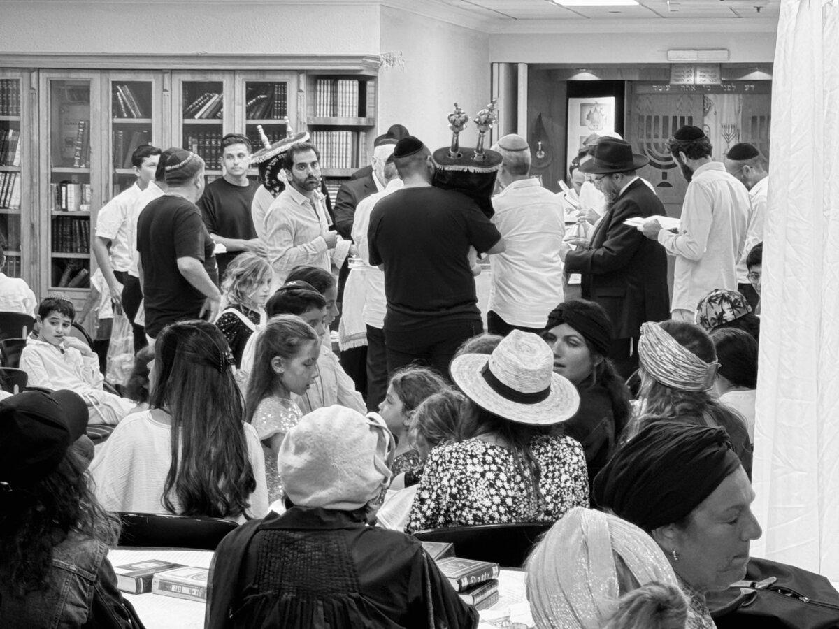Jewish men conduct a Simchat Torah service in a hotel basement in Netanya, Israel, during an air raid on Oct. 7, 2023. (Courtesy of Bishop Quigg Lawrence)