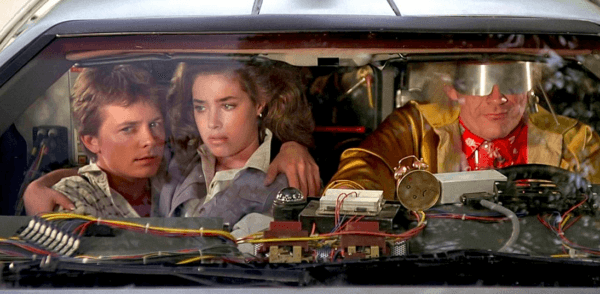 (L–R) Marty McFly (Michael J. Fox), Jennifer Parker (Claudia Wells), and Dr. Emmett Brown (Christopher Lloyd) ready to take off, back to the future, in "Back to the Future." (Universal Pictures)