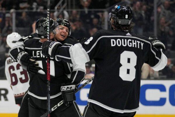 Los Angeles Kings center Blake Lizotte (c), celebrates with center Trevor Lewis (61) and defenseman Drew Doughty (8) after scoring during the second period of an NHL hockey game against the Arizona Coyotes in Los Angeles on Oct. 24, 2023. (Ashley Landis/AP Photo)