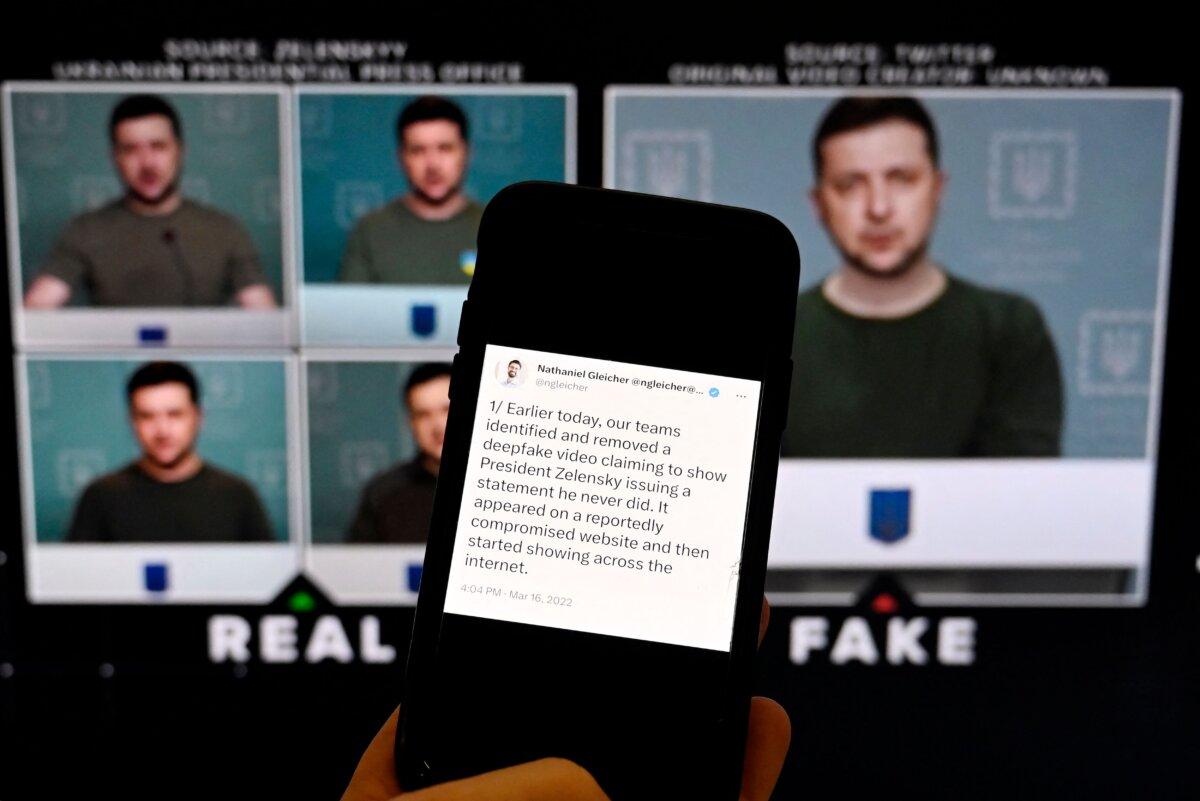 This illustration photo taken shows a phone screen displaying a statement from the head of security policy at Meta with a fake video (R) of Ukrainian President Volodymyr Zelenskyy calling on his soldiers to lay down their weapons shown in the background, in Washington, D.C., on on Jan. 30, 2023. (Olivier Douliery/AFP via Getty Images)