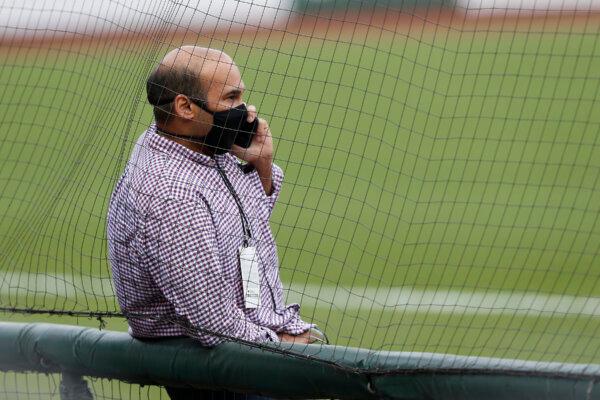 President of Baseball Operations Farhan Zaidi of the San Francisco Giants talks on the phone before the postponement of the game against the Los Angeles Dodgers at Oracle Park in San Francisco on Aug. 26, 2020. (Lachlan Cunningham/Getty Images)