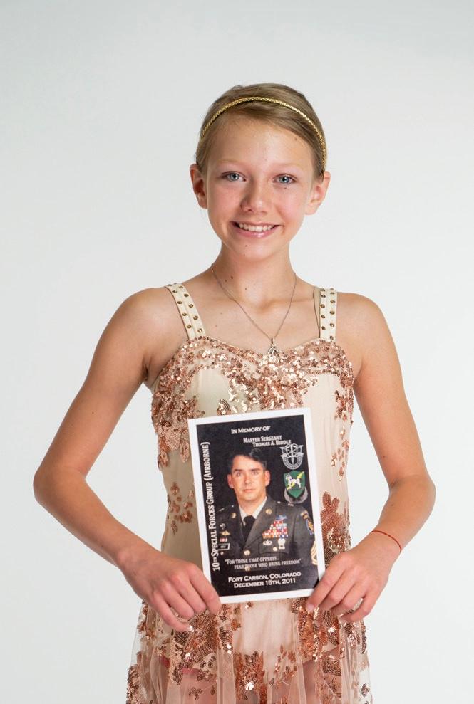 Haley with a photo of her father. Angels of the Fallen has supported her interests in cheer, dance, and volleyball. (Courtesy of Angels of the Fallen)