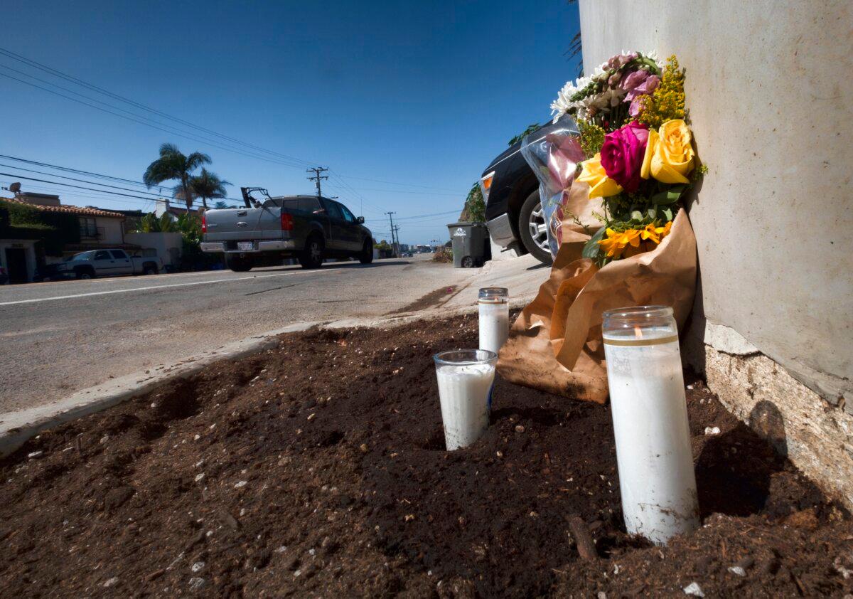 Candles and flowers are placed along along the Pacific Coast Highway, after a crash that killed four college students and injured two others, in Malibu, Calif., on Oct. 19, 2023. (Richard Vogel/AP Photo)