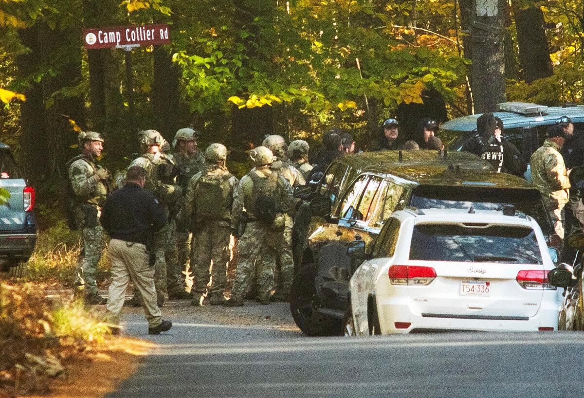 Massachusestts State Police troopers gather at the intersection of Kelton St. and Camp Collier Road in Gardner, Mass., on Oct. 24, 2023, during a search for Aaron Pennington. (Rick Cinclair/Worcester Telegram & Gazette via AP)