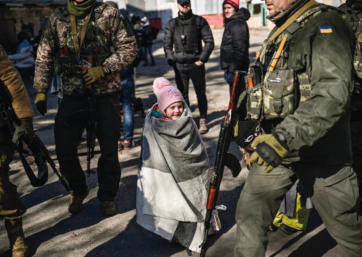 A child waits to be evacuated from the city of Irpin, north of Kyiv, on March 10, 2022. (ARIS MESSINIS/Contributor/AFP/ Getty Images)