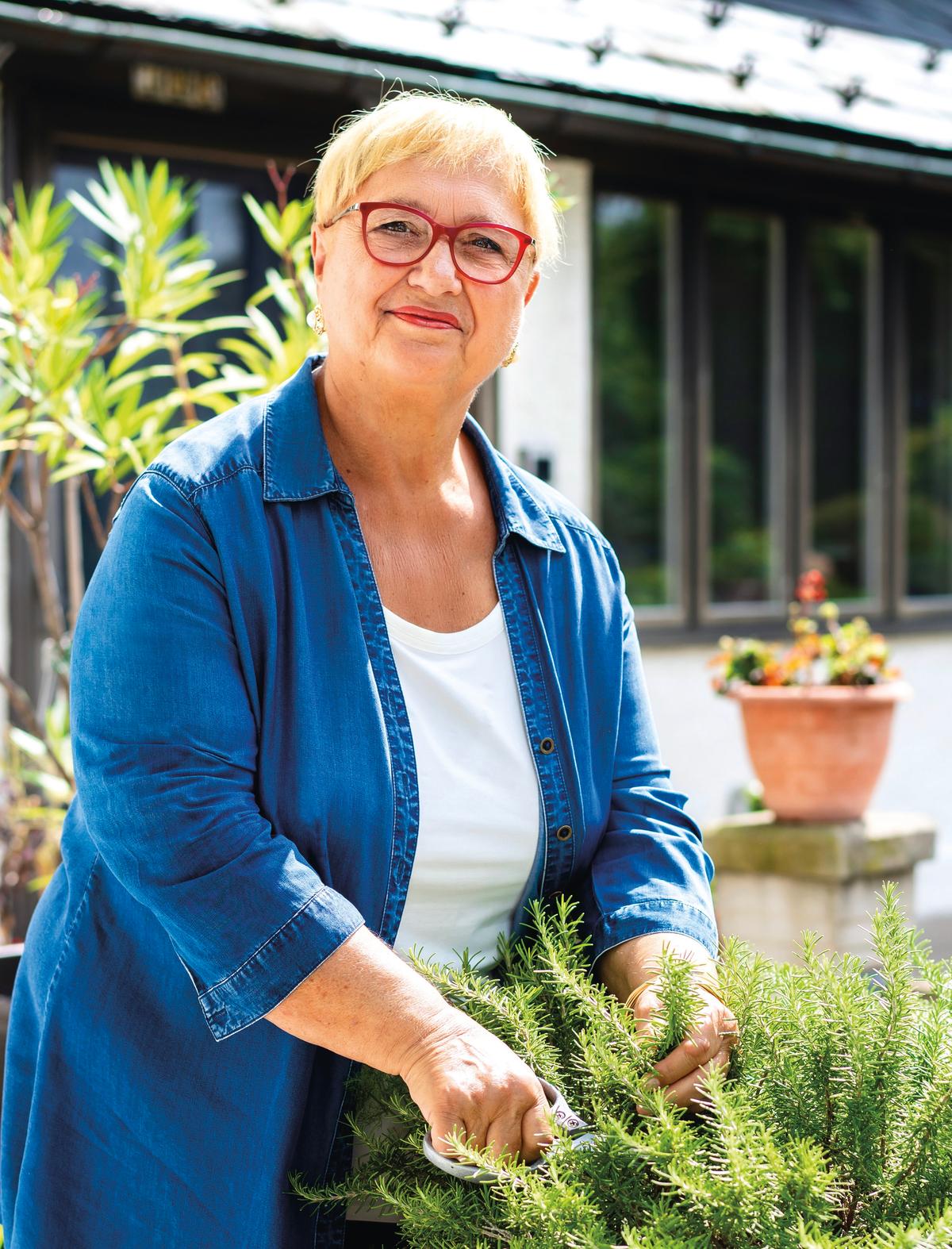 Ms. Bastianich harvests sprigs of fresh rosemary from her garden. (Samira Bouaou for American Essence)