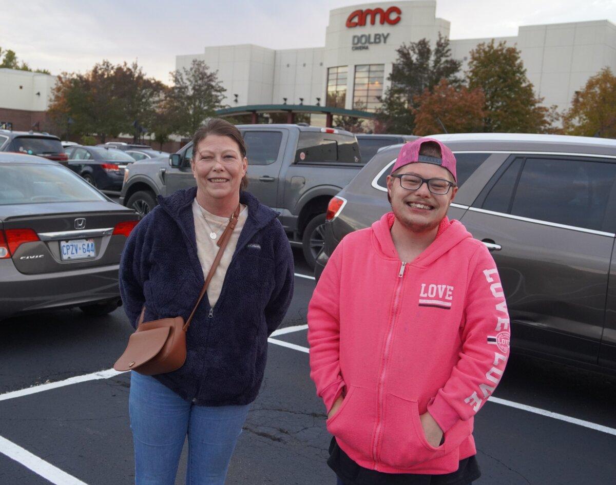 A mother and her son on their way into the premiere of 'Police State' in Sterling Heights, Mich. on Oct. 23, 2023. (Steven Kovac/Epoch Times)