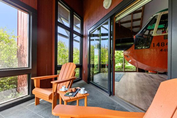 The patio at the Helicopter Cottage, with the nose of the retired U.S. Coast Guard Sikorsky Sea King Pelican HH3F rescue chopper, in the background. The interior of the helicopter has been refurbished as a lounge with a TV, couch, and wet bar. (Courtesy of Winvian Farm)