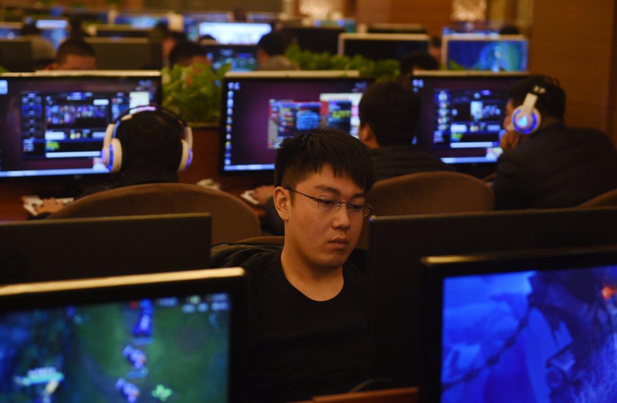 Men play games on computers in an internet bar in Beijing on Dec. 16, 2015. (Greg Baker/AFP via Getty Images)