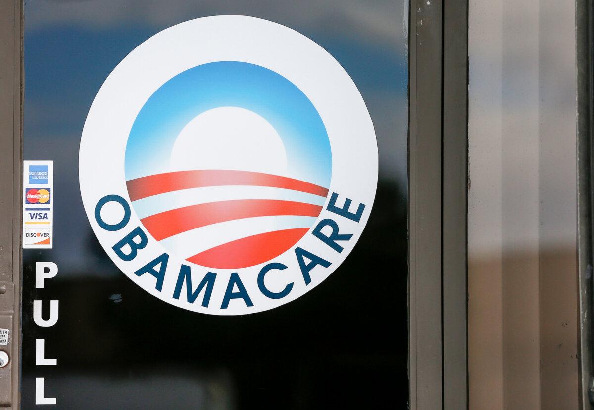 An Obamacare logo on the door of the UniVista Insurance agency in Miami on Jan. 10, 2017. (Rhona Wise/AFP via Getty Images)