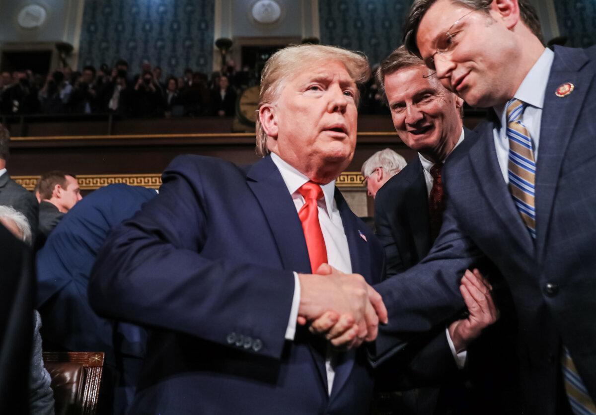 President Donald Trump is greeted by Rep. Mike Johnson (R-La.) before the State of the Union address in the House chamber in Washington on Feb. 4, 2020. (Leah Millis-Pool/Getty Images)