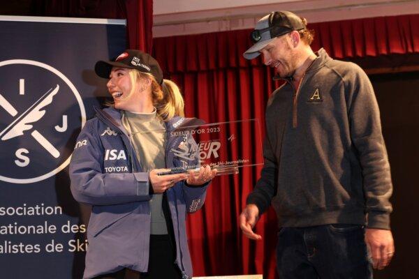 United States' Mikaela Shiffrin, (L), receives the Golden Skier award from US ski legend Bode Miller, ahead of the alpine ski season's opening races, in Soelden, Austria, on Oct. 27, 2023. (Alessandro Trovati/AP)