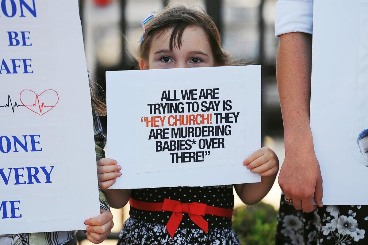 A child displays a sign in support of abortion legislation during a pro-life rally outside the Planned Parenthood Reproductive Health Center in St Louis, Mo., on June 4, 2019. (Michael B. Thomas/Getty Images)