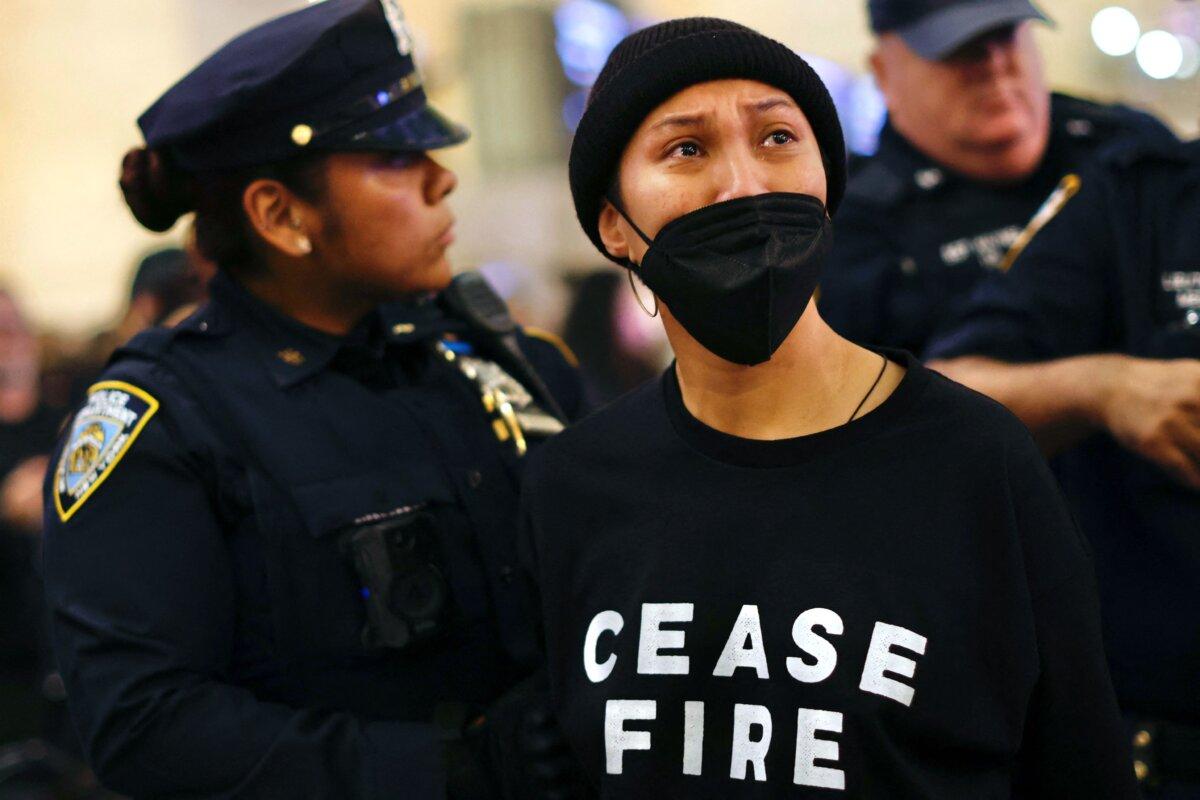 NYPD officers arrest a protester during a demonstration calling for a ceasefire amid war between Israel and Hamas, at Grand Central Station in New York City, on Oct. 27, 2023. (Kena Betancur/AFP via Getty Images)