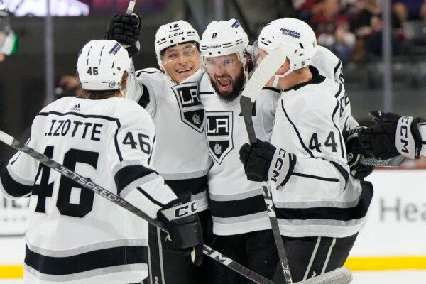 Los Angeles Kings defenseman Drew Doughty celebrates with center Blake Lizotte (46), center Trevor Moore (12) and defenseman Mikey Anderson (44) after scoring a goal against the Arizona Coyotes during the third period of an NHL hockey game Friday, Oct. 27, 2023, in Tempe, Ariz. (Rick Scuteri/AP Photo)