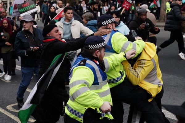 Police Officers clash with rival supporters as protesters walk past the Cenotaph on Whitehall during a pro-Palestine march organised by Palestine Solidarity Campaign in central London on Oct. 28, 2023. (Jordan Pettitt/PA)