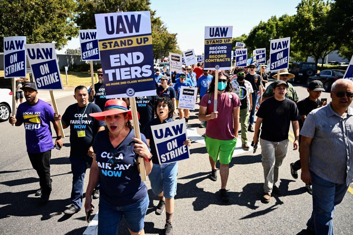 Labor supporters and members of the United Auto Workers (UAW) Local 230 march along a picket line during a strike outside of the Stellantis Chrysler Los Angeles Parts Distribution Center in Ontario, Calif., on Sept. 26, 2023. (Patrick T. Fallon/AFP via Getty Images)