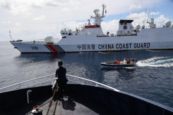 A Chinese coast guard ship (R) blocking a Philippine Bureau of Fisheries and Aquatic Resources' (BFAR) ship (L) while its personnel aboard a rigid hull inflatable boat sailing past the Philippine ship as it neared the Chinese-controlled Scarborough Shoal in the disputed South China Sea on Sept. 22, 2023. (Ted Aljibe/AFP via Getty Images)