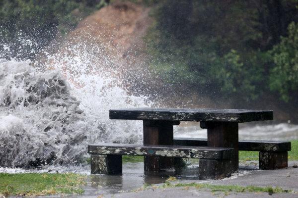 Waves crash over walkways at Matheson Bay in Auckland, New Zealand, on Oct. 30, 2023. (Fiona Goodall/Getty Images)