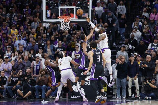 LeBron James (23) of the Los Angeles Lakers makes a basket to tie the game in the fourth quarter against the Sacramento Kings in Sacramento, Calif., on Oct. 29, 2023. (Lachlan Cunningham/Getty Images)