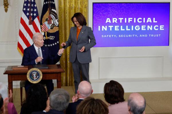 President Joe Biden hands Vice President Kamala Harris the pen he used to sign a new executive order regarding artificial intelligence during an event in the East Room of the White House on October 30, 2023 in Washington. (Chip Somodevilla/Getty Images)
