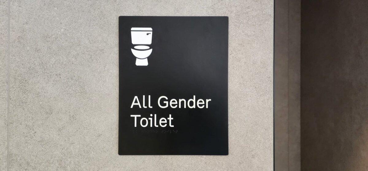 Signage denoting a unisex bathroom can be seen at Melbourne Airport, Australia, on Oct. 31, 2023. (Susan Mortimer/The Epoch Times)
