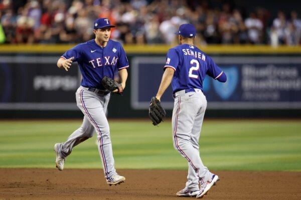 PHOENIX, ARIZONA - OCTOBER 30: Corey Seager #5 and Marcus Semien #2 of the Texas Rangers celebrate after the eighth inning against the Arizona Diamondbacks during Game Three of the World Series at Chase Field on October 30, 2023 in Phoenix, Arizona. (Photo by Christian Petersen/Getty Images)