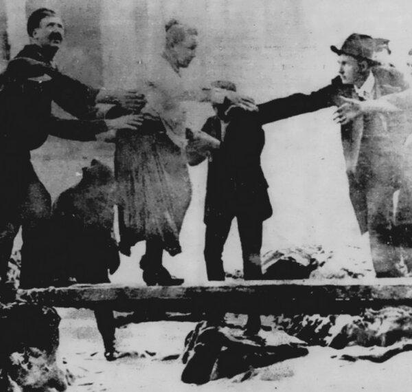 Taylor being helped to shore after her adventure. (Public Domain)