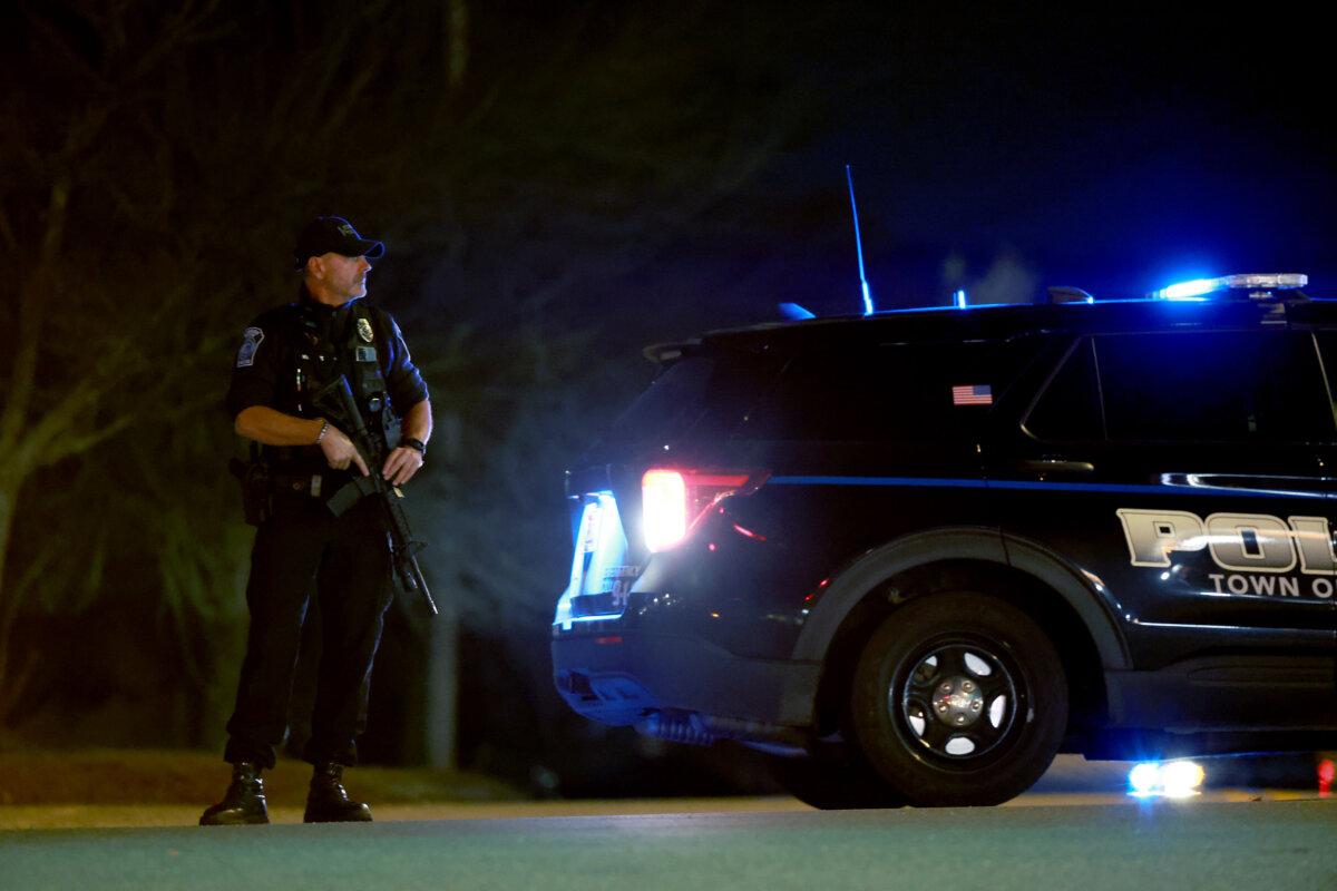 Police man a roadblock leading to the area that Robert Card, the then-suspect in two mass killings, was found dead in Lisbon, Maine, on Oct. 27, 2023. (Joe Raedle/Getty Images)