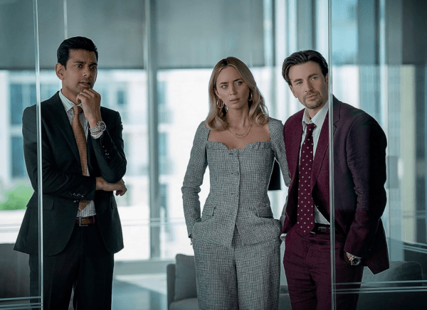 (L–R) Eric Paley (Amit Shah), Liza (Emily Blunt), and Pete Brenner (Chris Evans), in "Pain Hustlers." (Brian Douglas/Netflix)