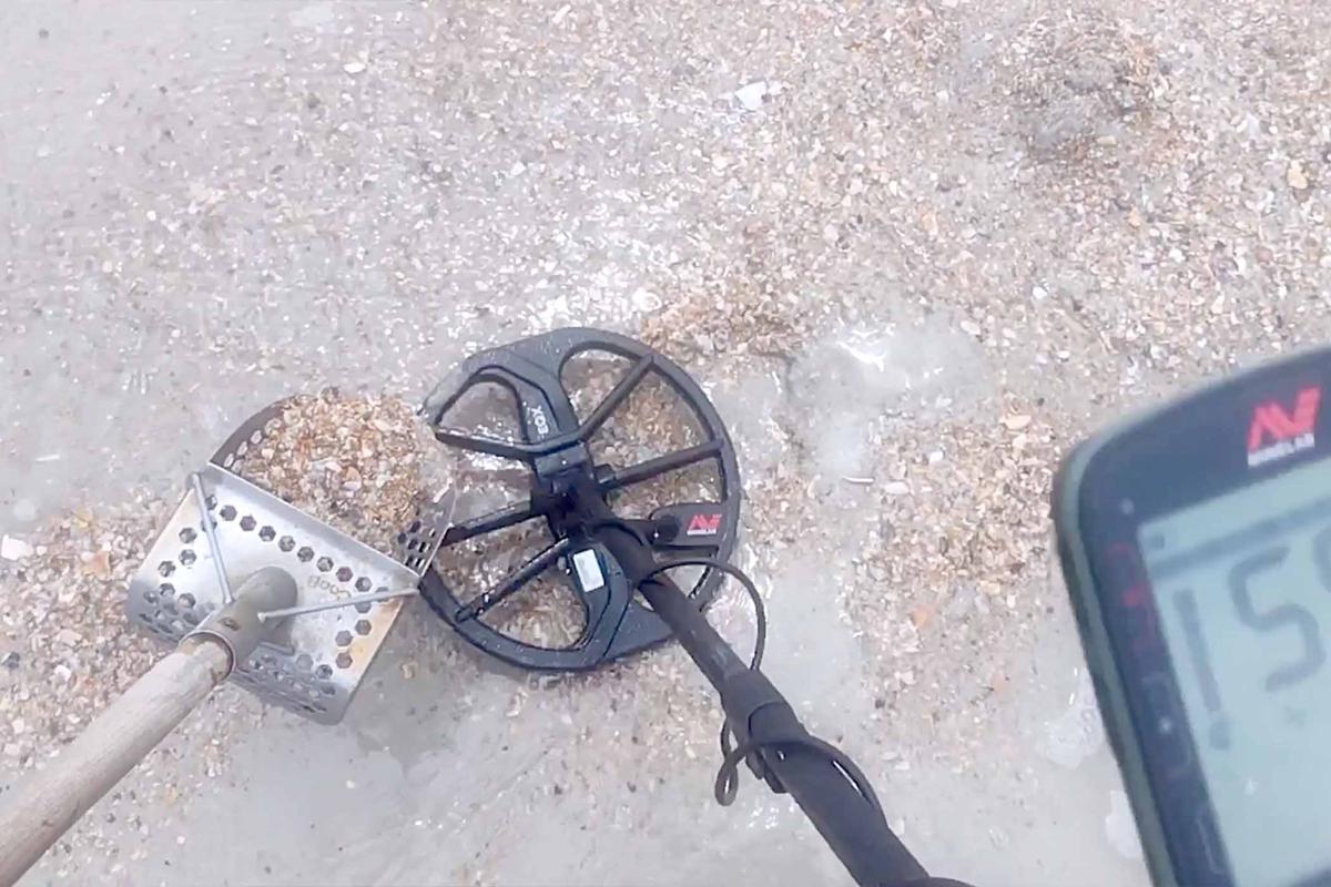 Metal detectorist Joseph Cook, 38, finds the lost wedding ring with his metal detector on a beach in St. Augustine, Florida. (Screenshot/Newsflare)