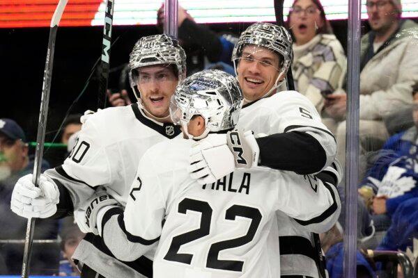 Los Angeles Kings' Andreas Englund, right, celebrates with Kevin Fiala (22) and Pierre-Luc Dubois after scoring against the Toronto Maple Leafs during the first period of an NHL hockey game in Toronto on Oct. 31, 2023. (Chris Young/The Canadian Press via AP Photo)