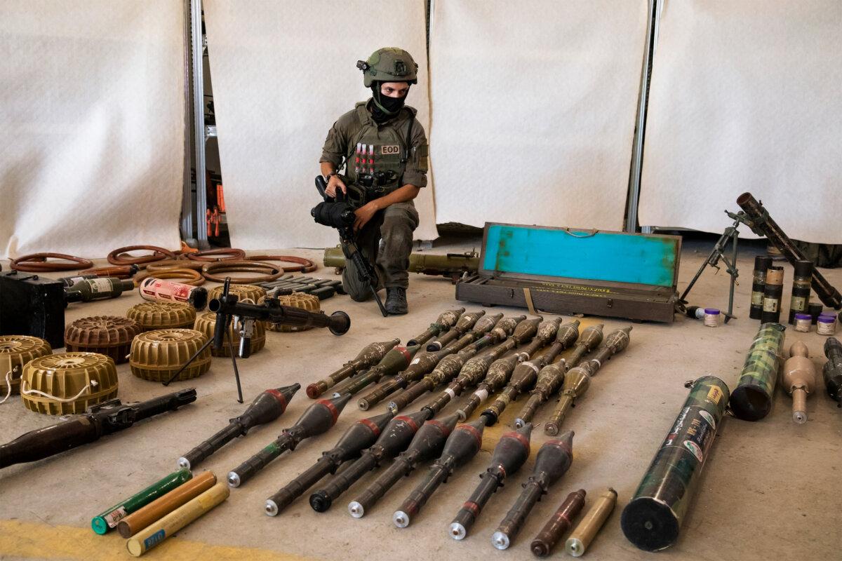 An Israeli soldier displays military equipment and ammunition that Hamas terrorists used at the time of the attack on Israel, in Kiryat Malakhi, Israel, on Oct. 20, 2023. (Amir Levy/Getty Images)