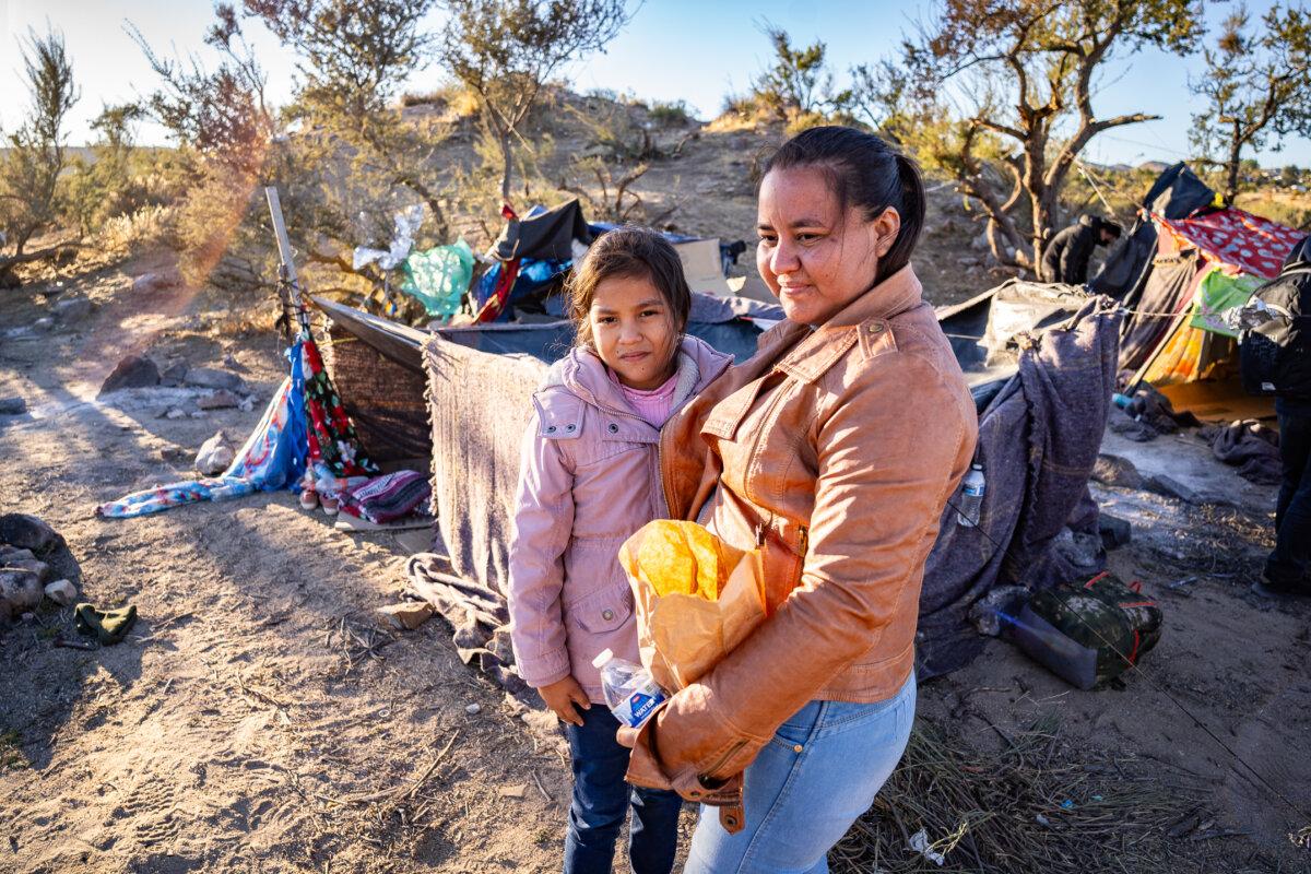 A Guatemalan mother and her daughter stand near their tent in Jacumba, Calif., on Oct. 31, 2023. (John Fredricks/The Epoch Times)