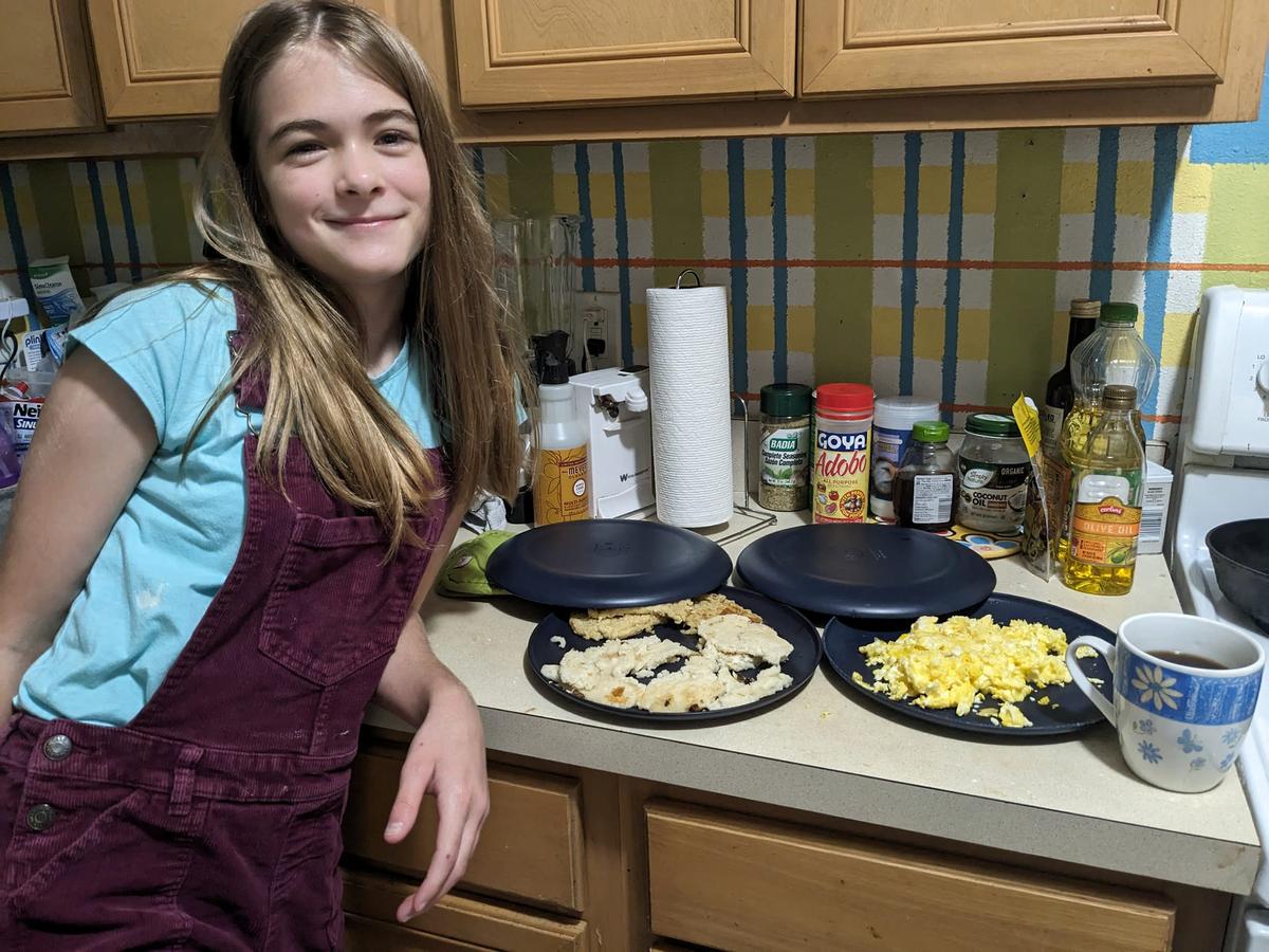 Aurora Crawford, 12, with the pancakes and scrambled eggs she cooked for her family. (Courtesy of Crystal Crawford)