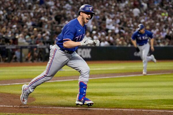 Texas Rangers' Mitch Garver celebrates after a RBI single against the Arizona Diamondbacks during the seventh inning in Game 5 of the baseball World Series in Phoenix on Nov. 1, 2023. (Brynn Anderson/AP Photo)