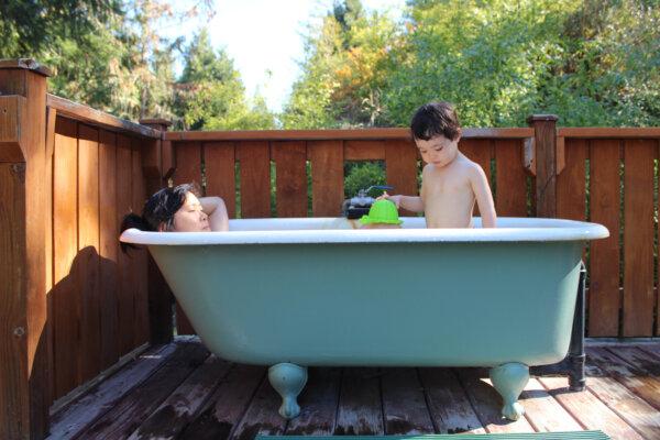 The author’s wife and daughter relax in a bathtub filled with geothermal mineral water at Breitenbush Hot Springs in central Oregon. (Gregory Scruggs/The Seattle Times/TNS)