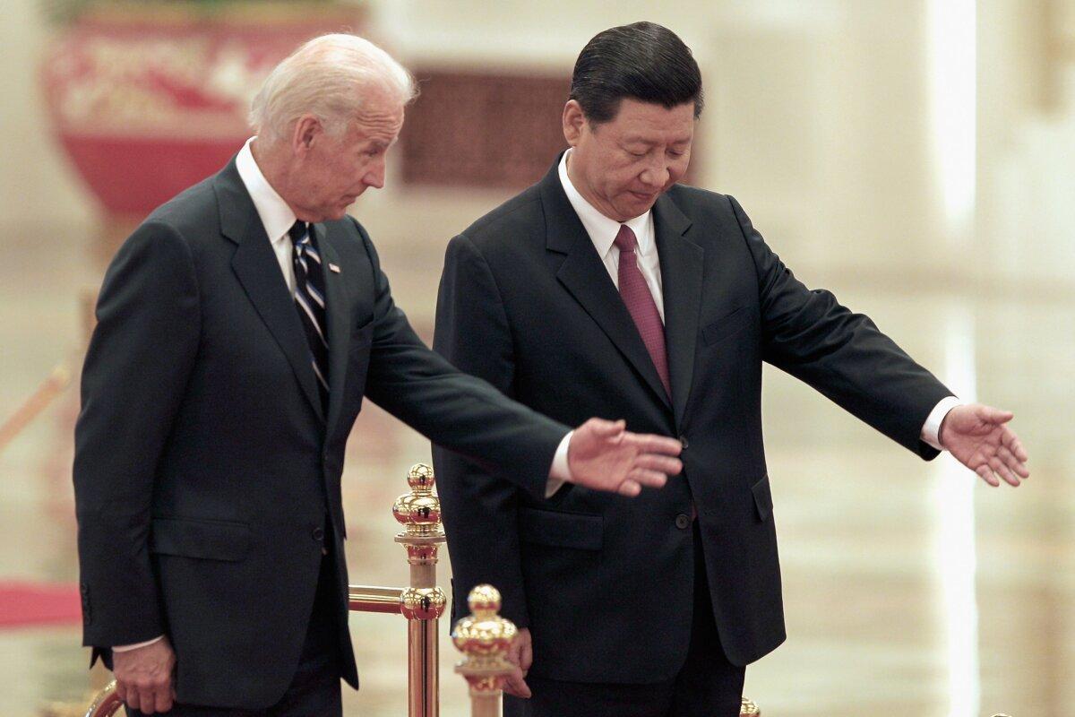Then-Chinese Vice President Xi Jinping accompanies then-U.S. Vice President Joe Biden to view an honor guard during a welcoming ceremony inside the Great Hall of the People in Beijing on Aug. 18, 2011. (Lintao Zhang/Getty Images)