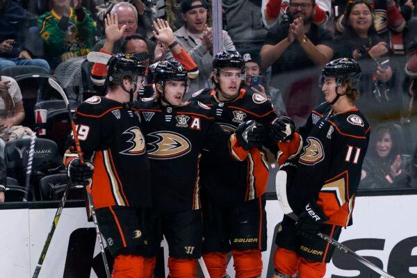 Anaheim Ducks right wing Troy Terry, second from left, celebrates his goal against the Arizona Coyotes with left wing Max Jones,center Leo Carlsson, and center Trevor Zegras, from left, during the first period of an NHL hockey game in Anaheim, Calif., on Nov. 1, 2023. (Ryan Sun/AP Photo)