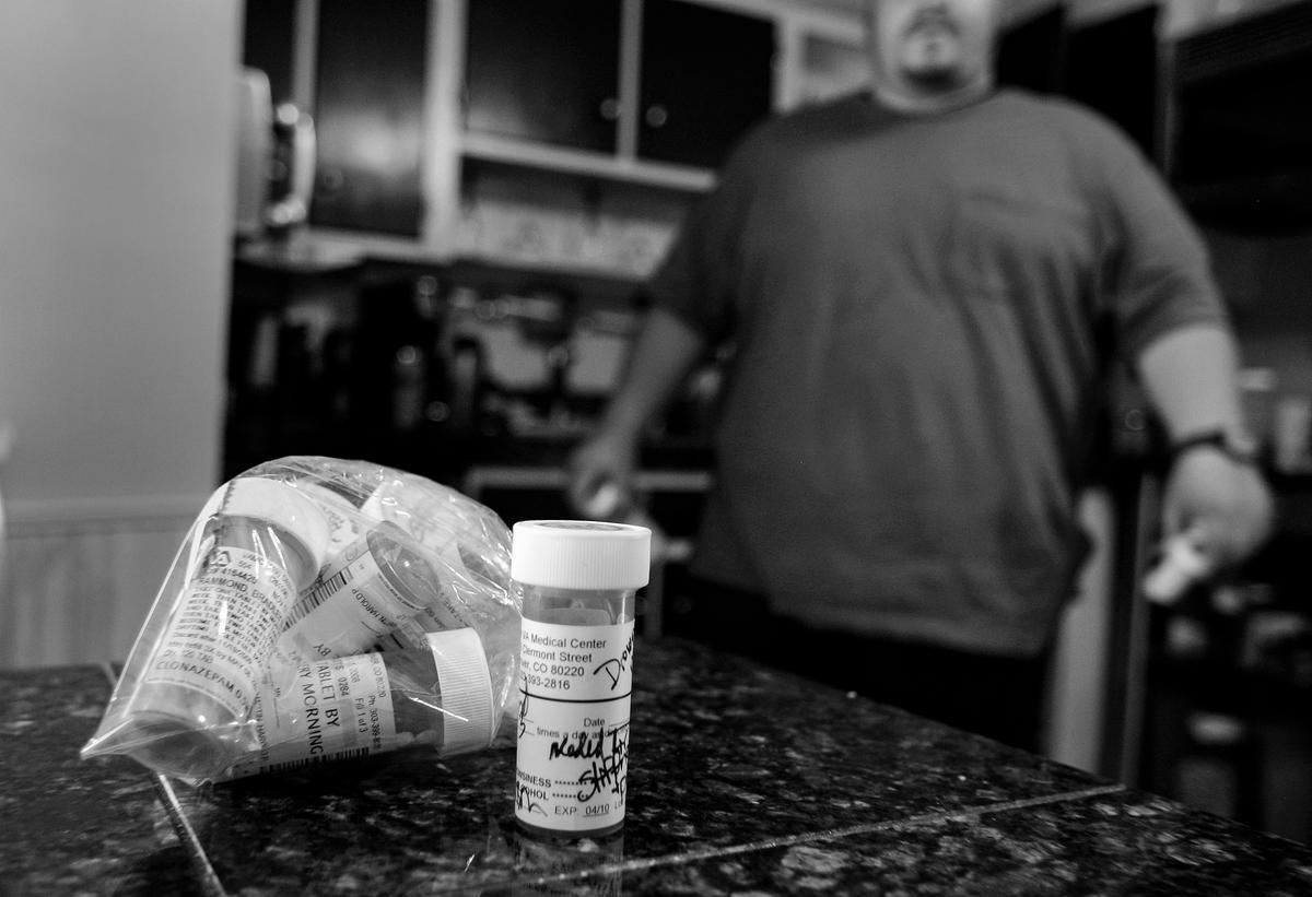  Un veterano de la guerra de Irak camina en su cocina cerca de algunos de los muchos medicamentos recetados que le han recetado los médicos para ayudarlo a sobrellevar su trastorno de estrés postraumático, en esta foto de archivo. (Chris Hondros/Getty Images)