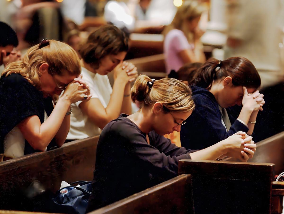 Parishioners pray at St. Patrick's Cathedral in New York City on Sept. 12, 2001, a day after a terrorist attack on the World Trade Center. (Jeff Kowalsky/AFP via Getty Images)
