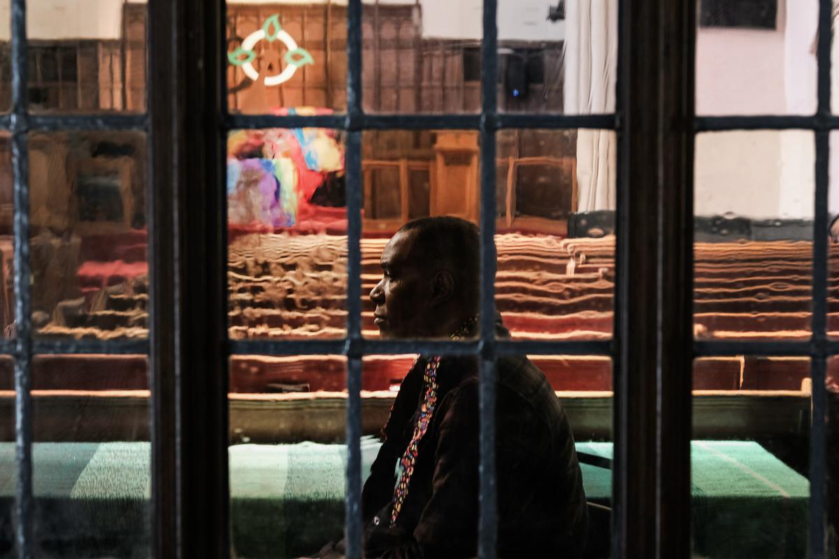 Roody Chatelain, a worshipper at the Church of the Village, waits to administer a glitter ash cross on a forehead during a service at the church that serves members of the LGBT community, in New York City on March 6, 2019. (Spencer Platt/Getty Images)