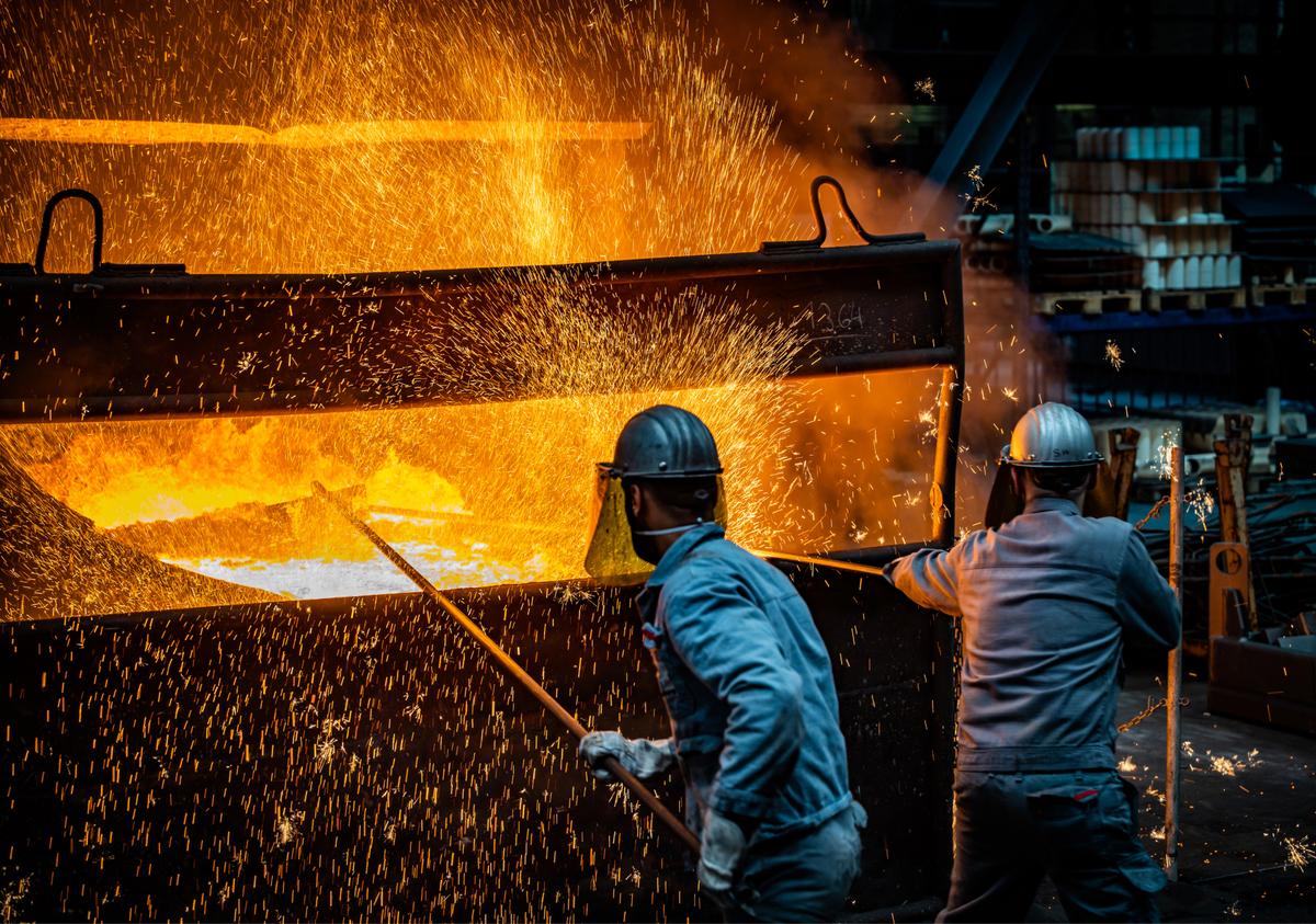  Workers prepare to pour ductile iron casting molten iron into a mould at the Siempelkamp Giesserei foundry in Krefeld, Germany, on April 21, 2022. The company has faced multifold price increases for its raw materials, including scrap iron, nickel, and aluminum, due to EU sanctions against Russia. A company spokesman said that a disruption to Germany's natural gas supply would bring much of the foundry's manufacturing ability to a halt. (Sascha Schuermann/Getty Images)