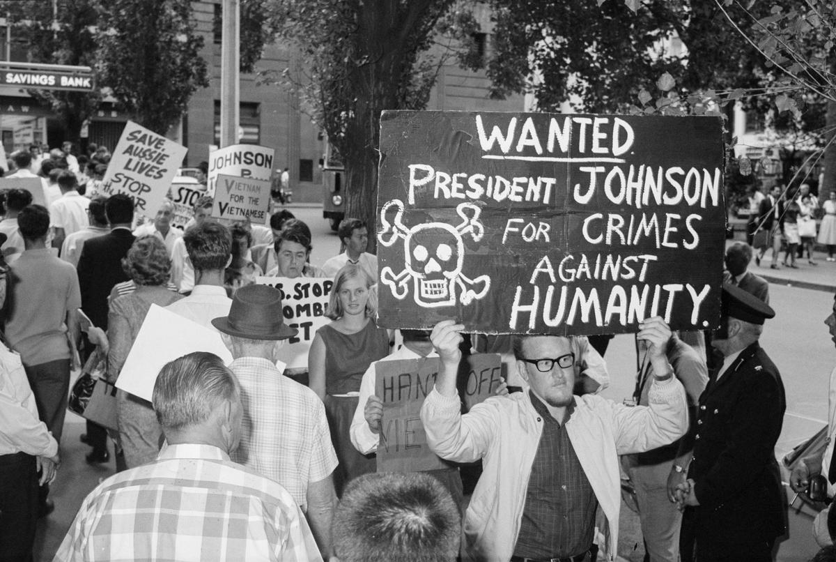  A protester holds up a sign calling for U.S. President Lyndon B. Johnson to face retribution for U.S. actions in the Vietnam War, at a protest in Sydney on Feb. 1, 1966. (The Tribune/SEARCH Foundation, CC BY 4.0)