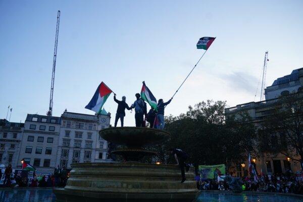 Demonstrators climbed on top of the fountain at a pro-Palestinian rally calling for a ceasefire in Gaza in Trafalgar Square, London, on Nov. 4, 2023. (Victoria Jones/PA Wire)